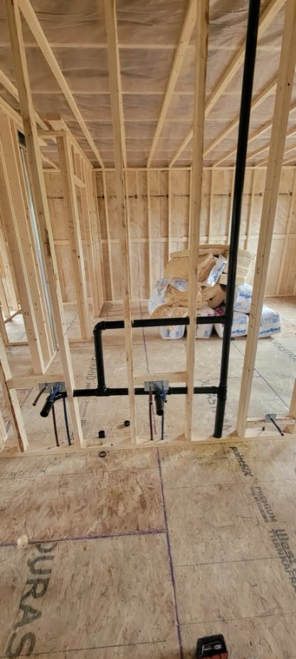 Plumbing drain and vent lines installed inside a newly framed house