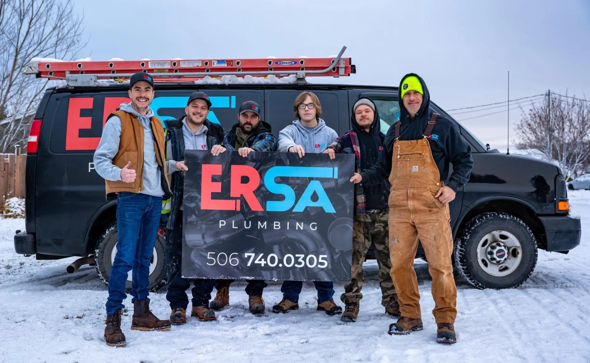 The ERSA Plumbing team posed with their service van in winter