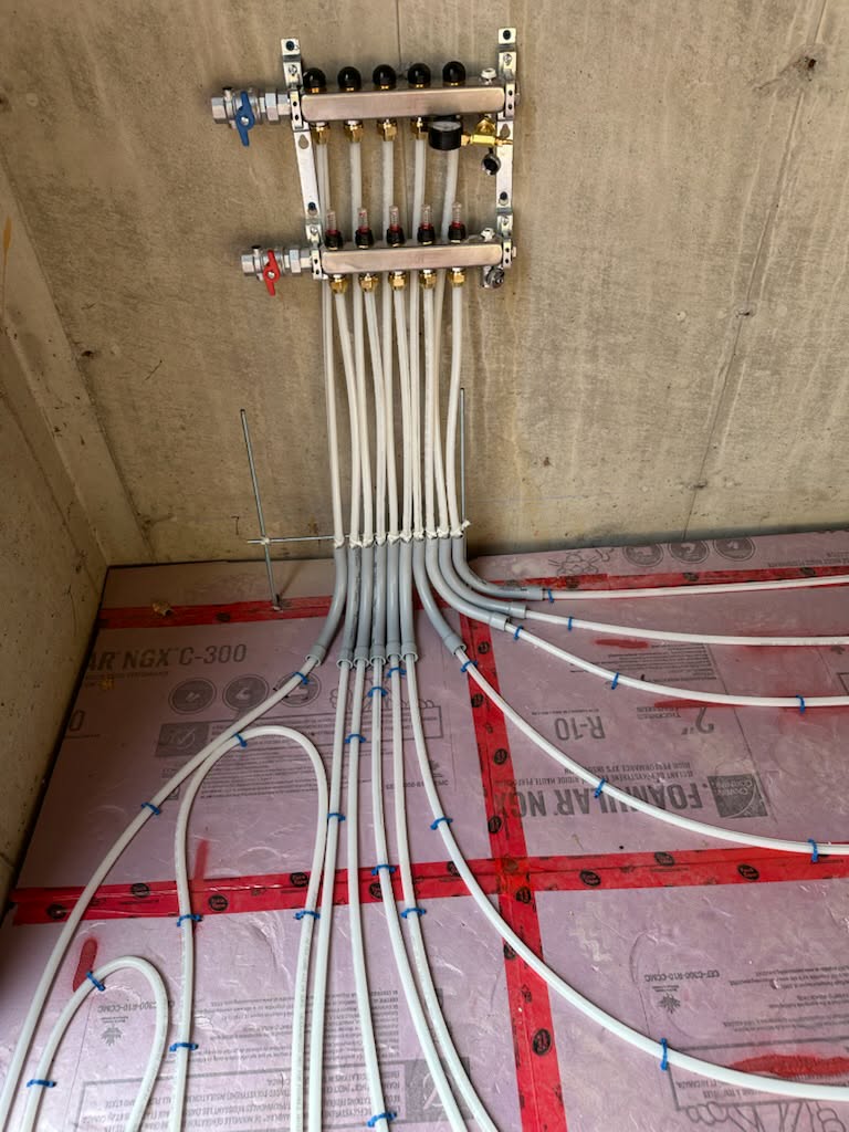 Radiant heating manifold and supply lines installed during a new house build