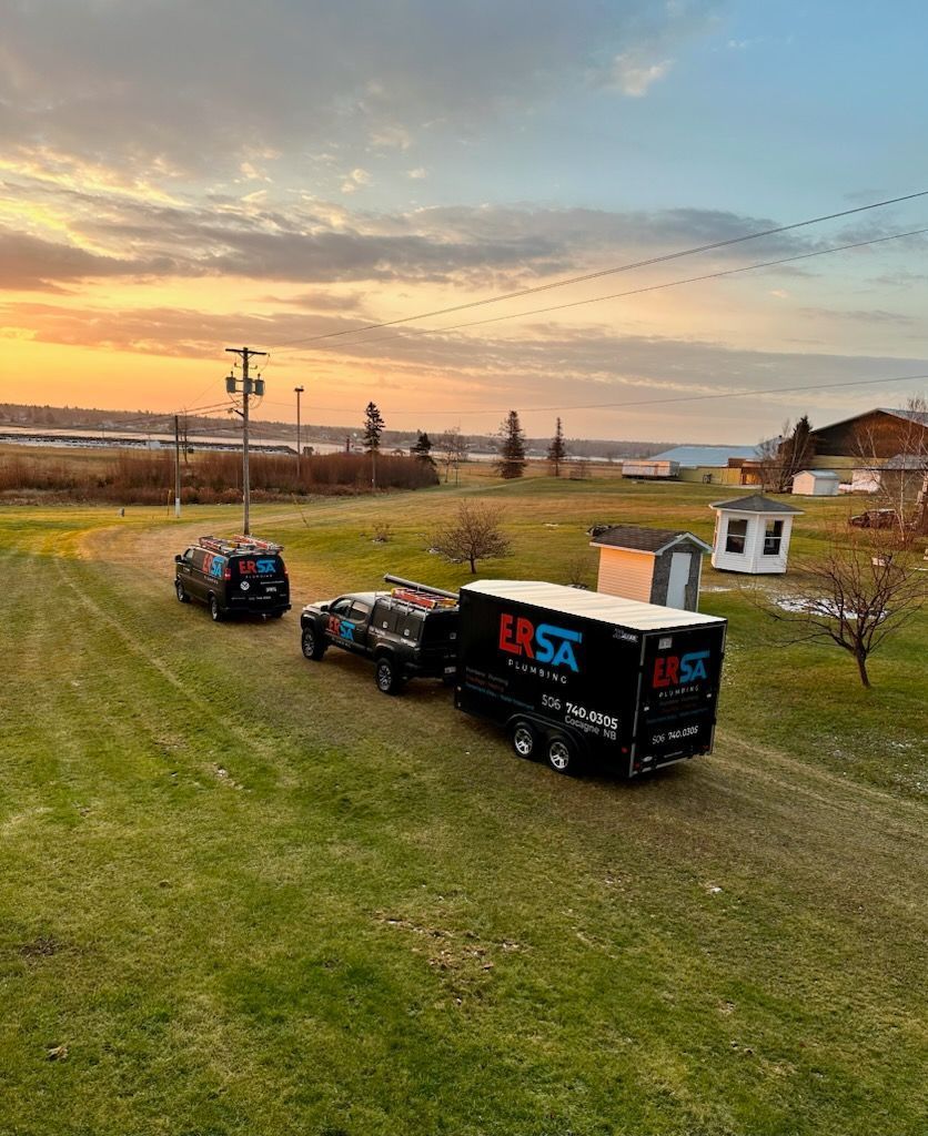 ERSA Plumbing service trailer parked on a job site at sunset