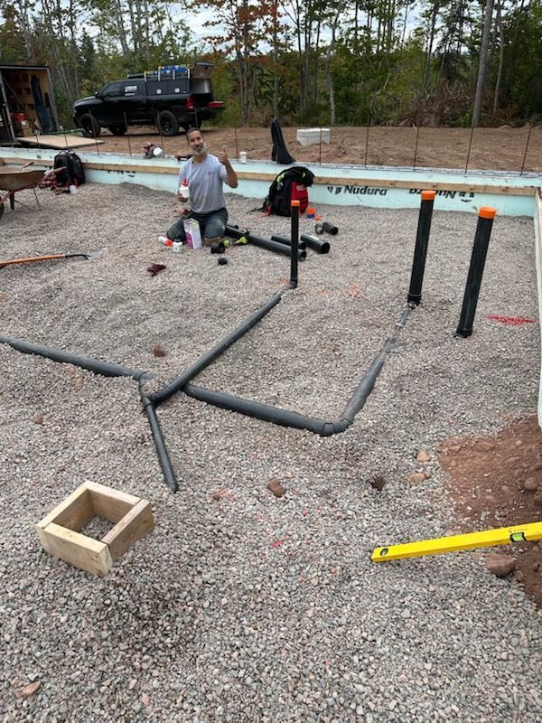 Underground plumbing rough-in laid out on a new foundation