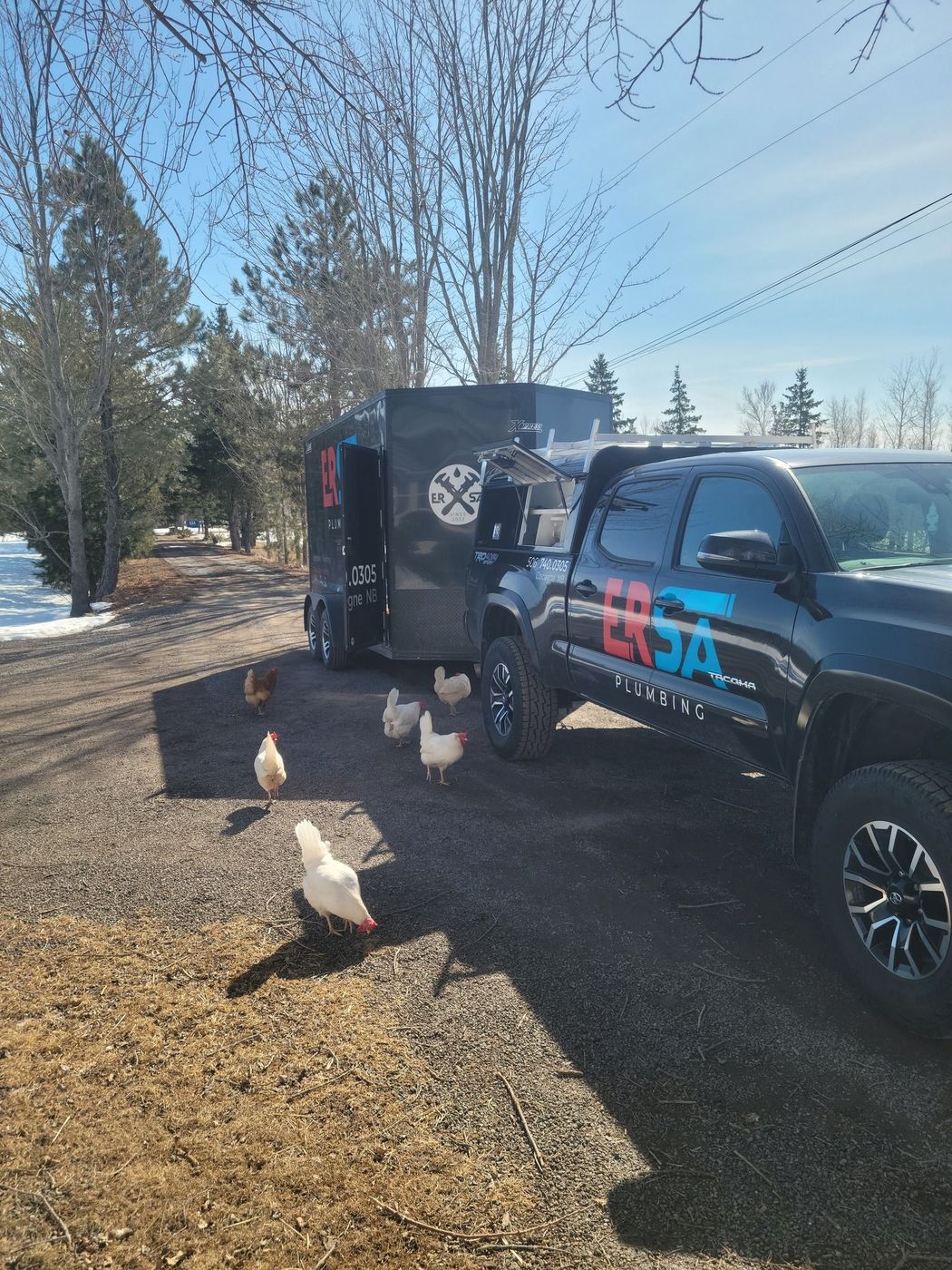 ERSA Plumbing truck and trailer on a winter job site