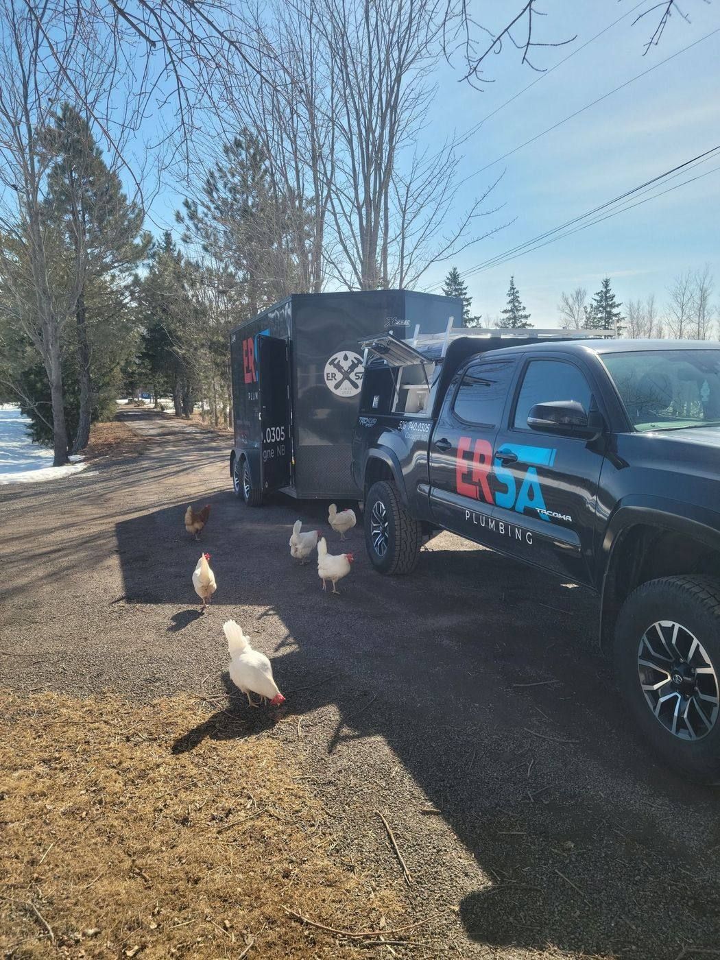 ERSA Plumbing truck and trailer on a winter job site