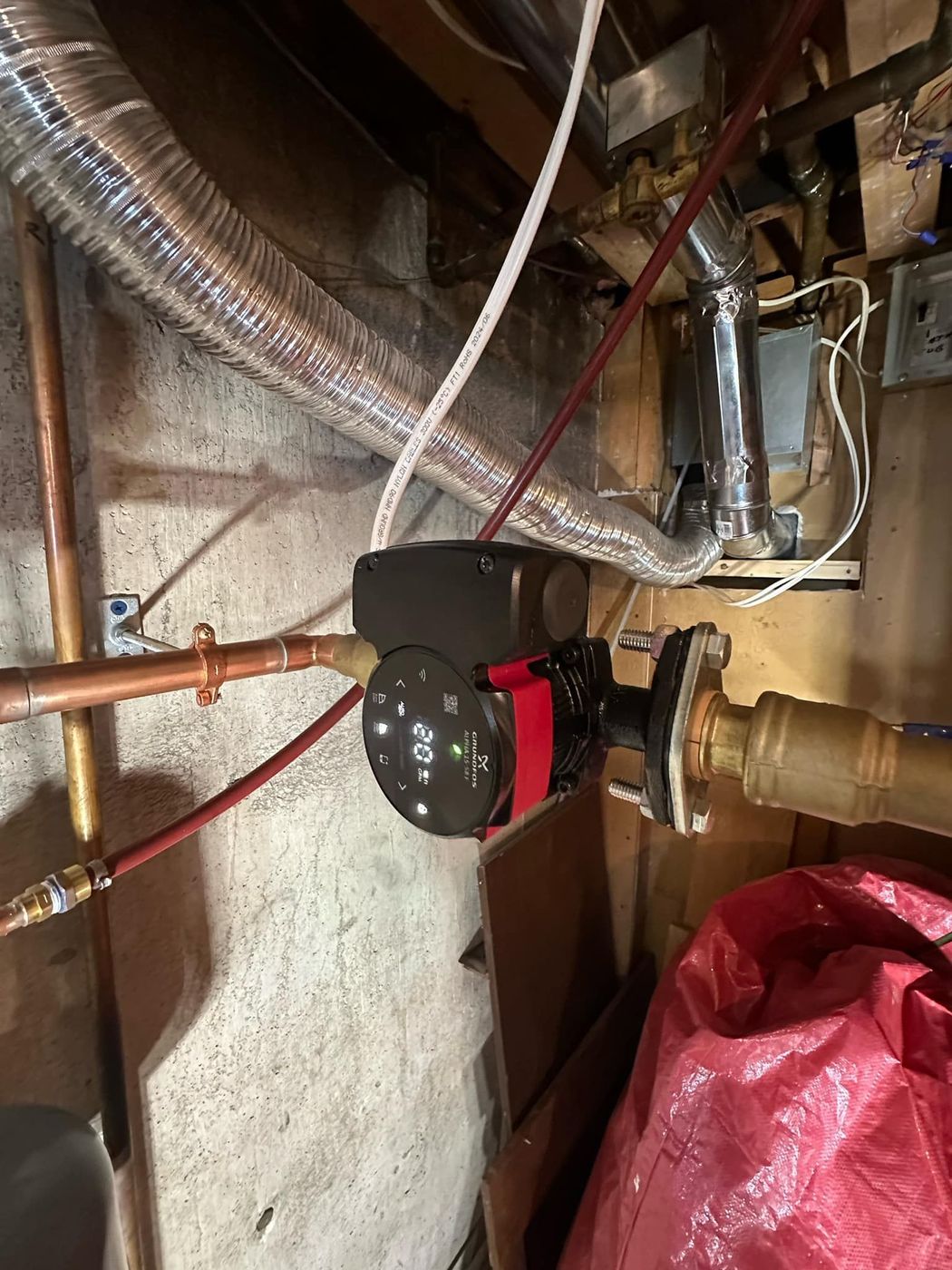 Copper piping and circulation pump in a residential mechanical room
