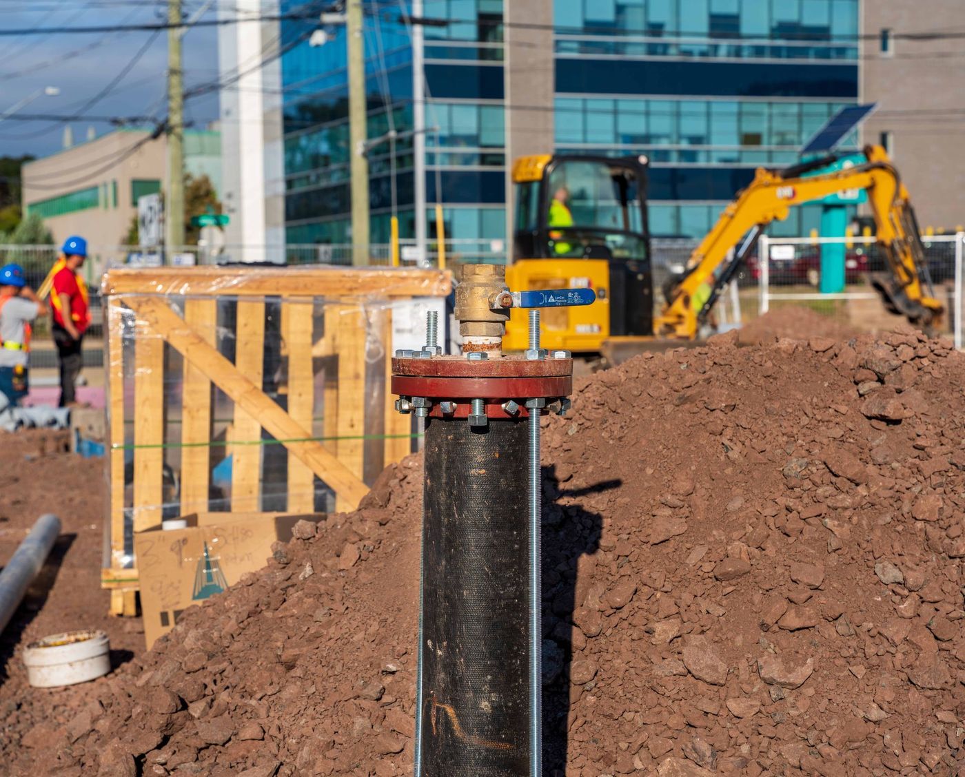ERSA Plumbing crew running water and sewer service lines on a commercial construction project