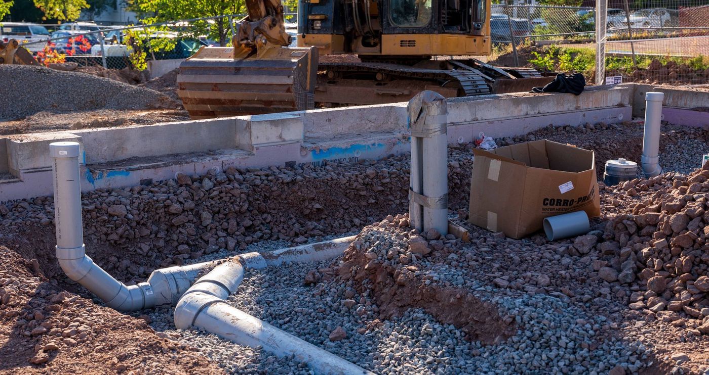 ERSA Plumbing crew running water and sewer service lines on a commercial construction project