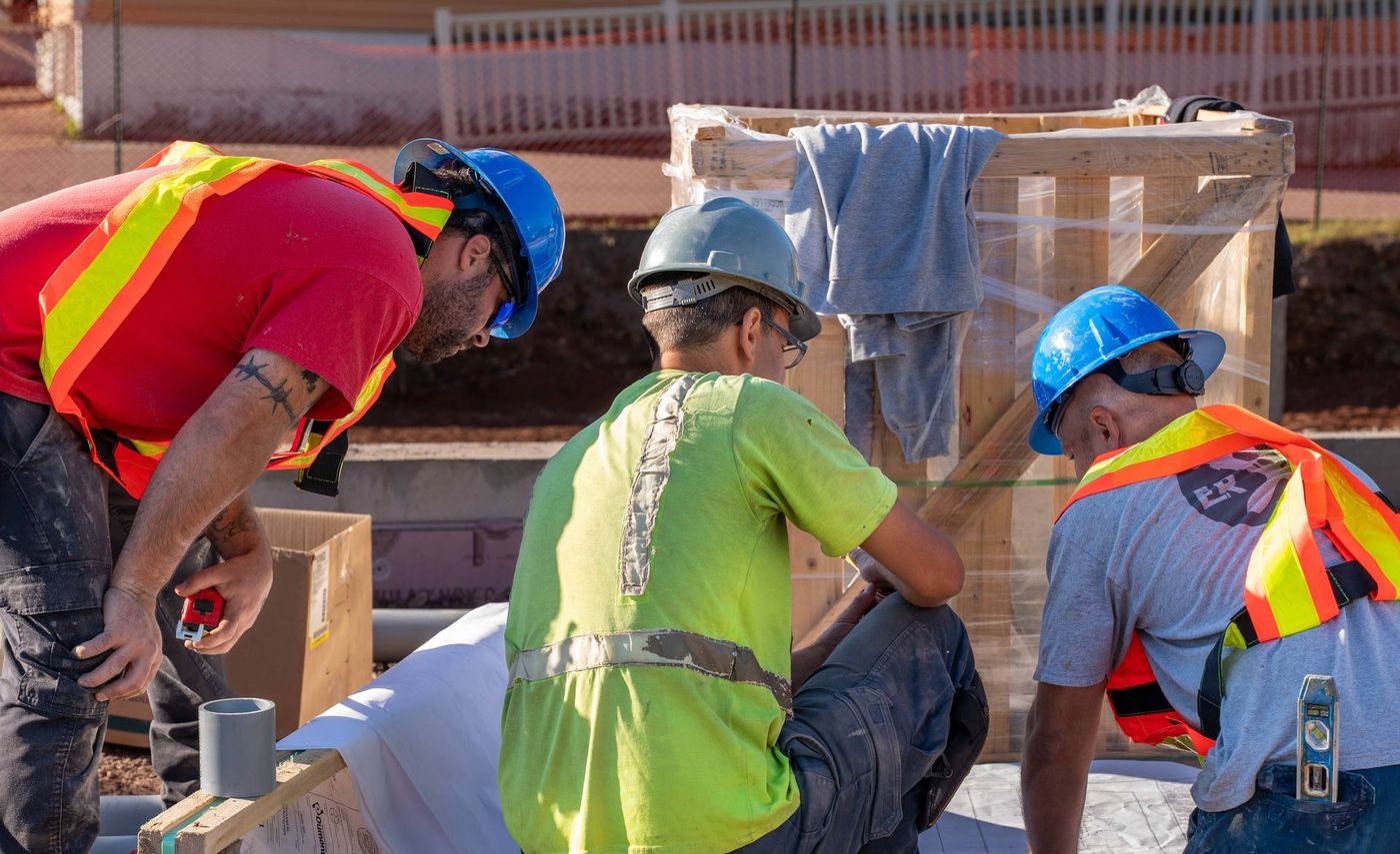 ERSA Plumbing crew running water and sewer service lines on a commercial construction project