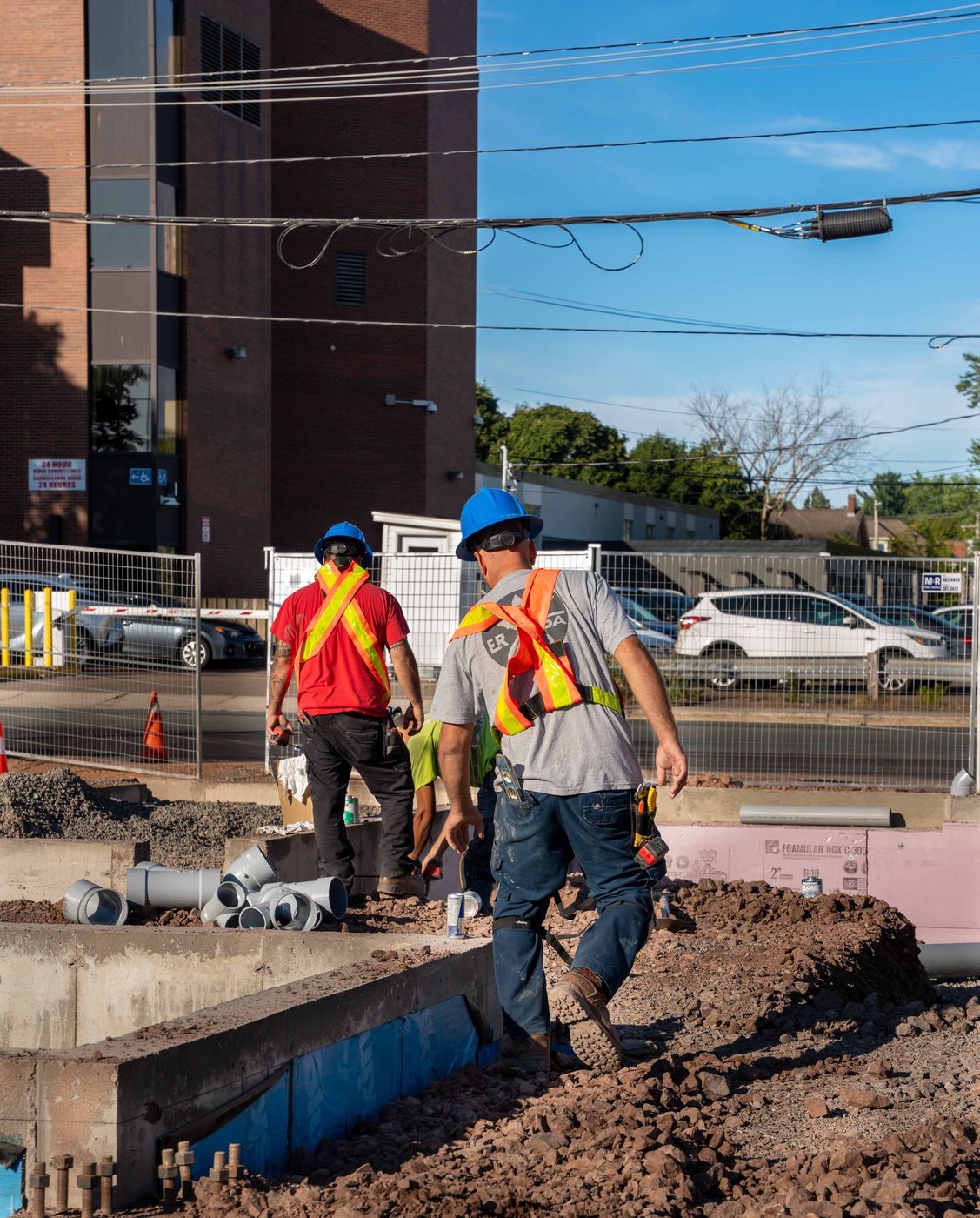 ERSA Plumbing crew running water and sewer service lines on a commercial construction project