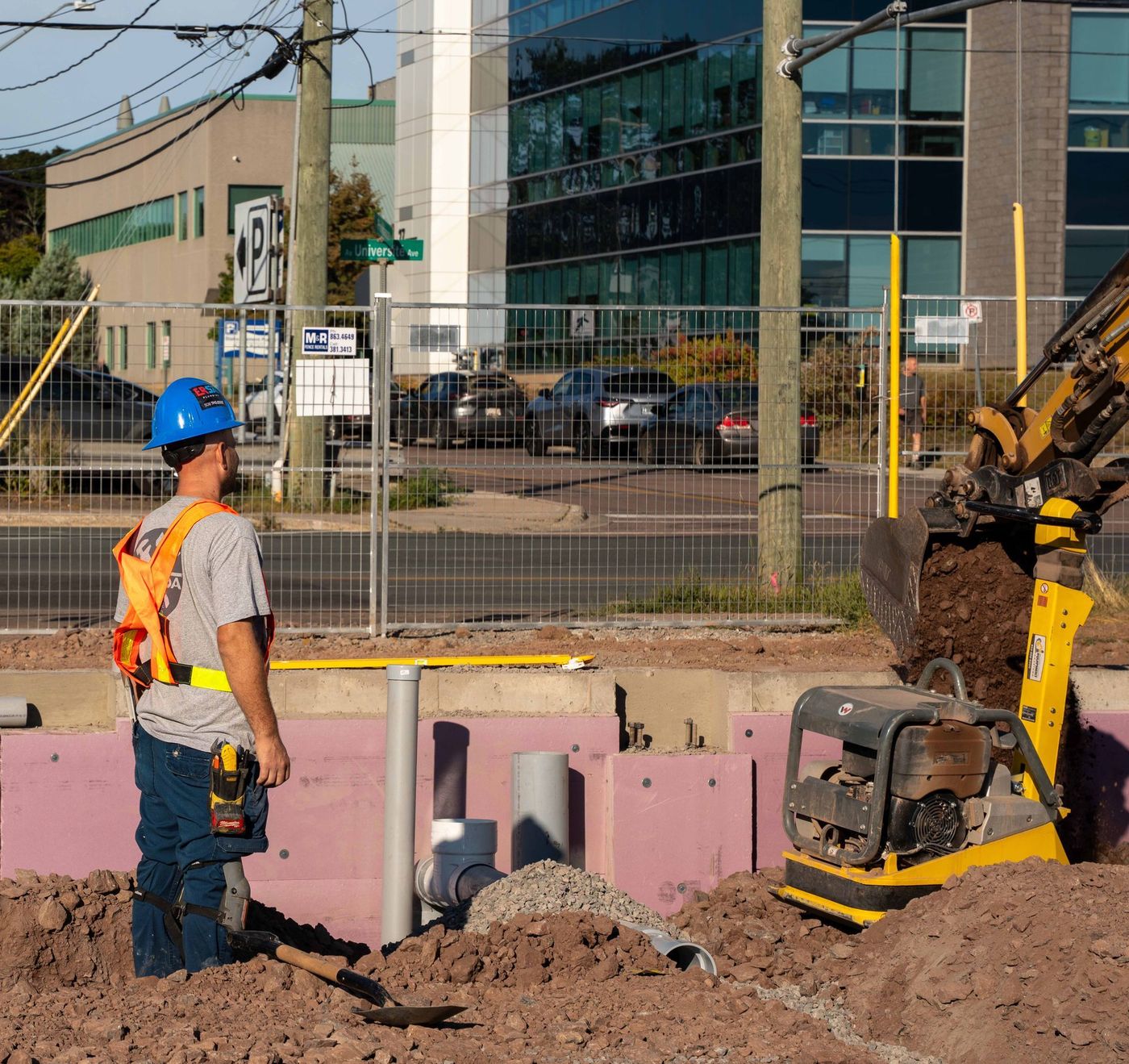 ERSA Plumbing crew running water and sewer service lines on a commercial construction project