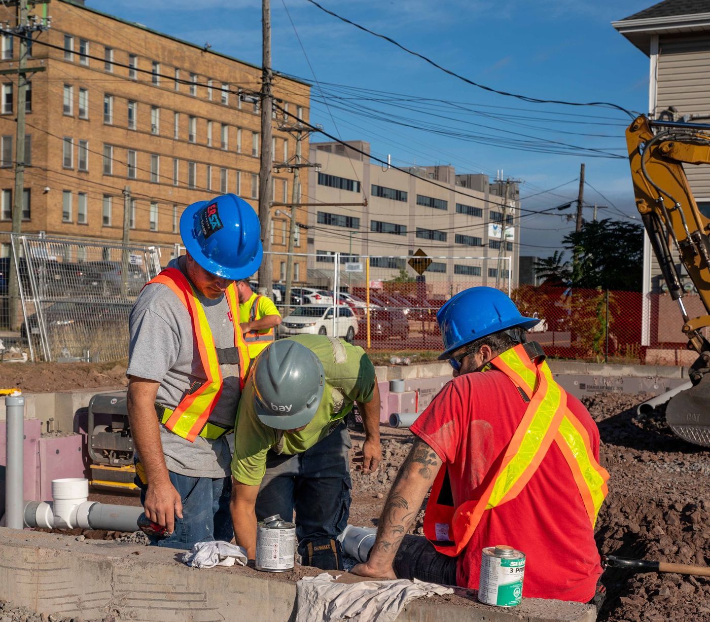 ERSA Plumbing crew running water and sewer service lines on a commercial construction project