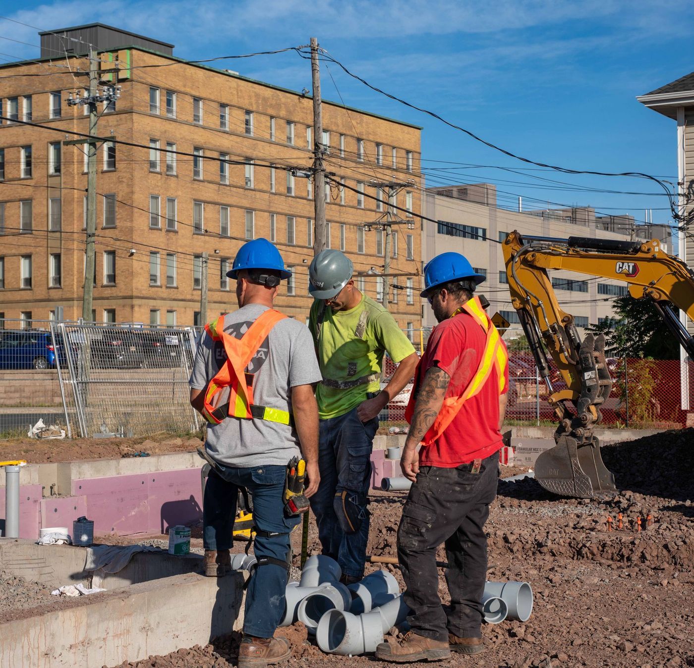 ERSA Plumbing crew running water and sewer service lines on a commercial construction project