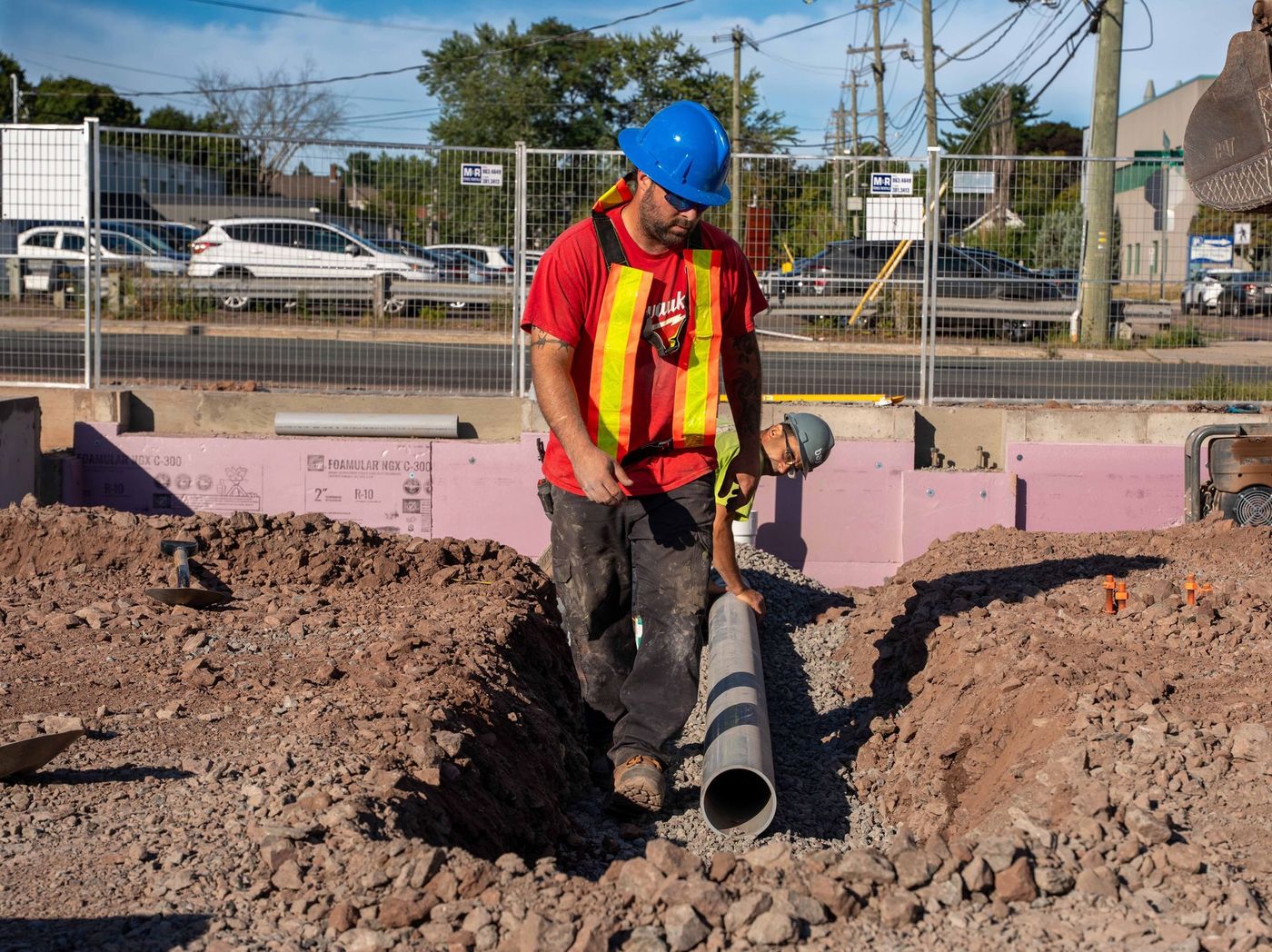 ERSA Plumbing crew running water and sewer service lines on a commercial construction project